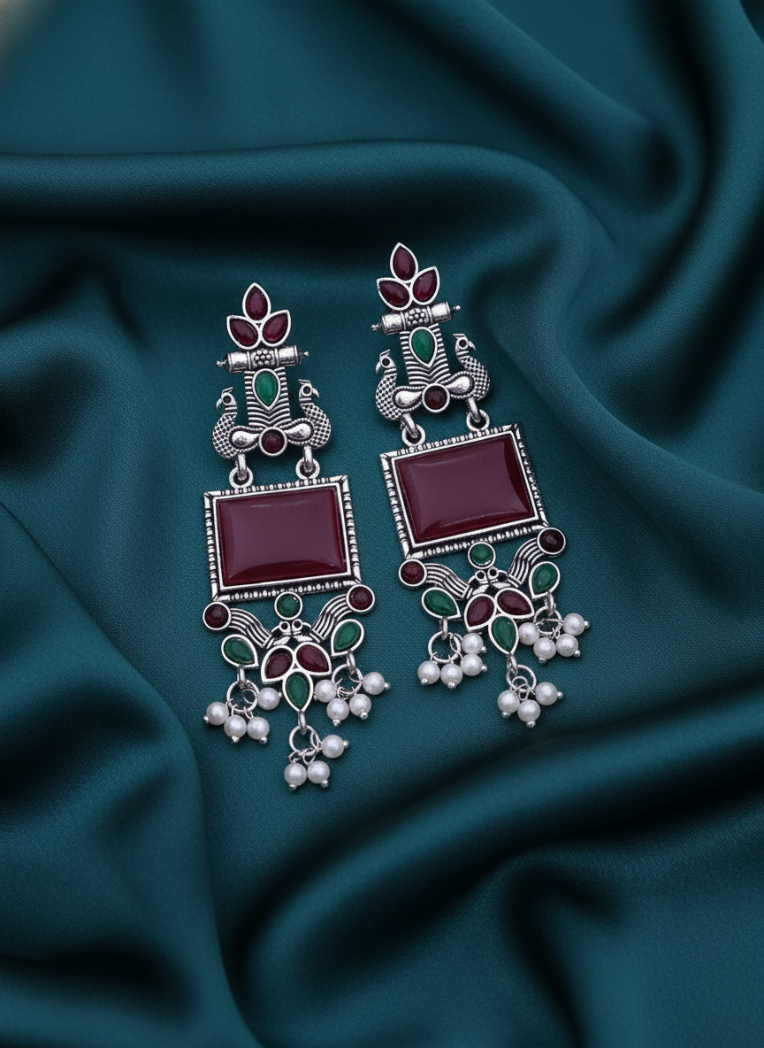 Exquisite Oxidized Silver Peacock Dangle Earrings with Maroon Stones