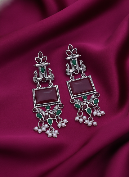 Exquisite Oxidized Silver Peacock Dangle Earrings with Maroon Stones